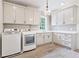 Functional laundry room with white cabinets, a washer and dryer, and a sink at 891 Glenbrook Nw Dr, Atlanta, GA 30318