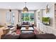 Living room with hardwood floors, built-in shelves, large window, and comfortable seating at 891 Glenbrook Nw Dr, Atlanta, GA 30318