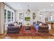 Cozy living room features hardwood floors, shiplap walls, comfortable sofas, and a decorative rug at 891 Glenbrook Nw Dr, Atlanta, GA 30318