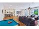 Spacious living room with a pool table, hardwood floors, shiplap walls and view of the kitchen at 891 Glenbrook Nw Dr, Atlanta, GA 30318