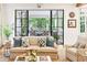 Cozy living room with a comfortable sofa, decorative pillows, and access to the outdoor living area at 891 Glenbrook Nw Dr, Atlanta, GA 30318