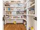 Organized walk-in pantry with ample shelving, hardwood floors, and a variety of storage options at 891 Glenbrook Nw Dr, Atlanta, GA 30318