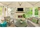 Charming covered patio with an outdoor fireplace, cozy seating, and a view of the lush surroundings at 891 Glenbrook Nw Dr, Atlanta, GA 30318
