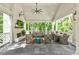Inviting covered patio with a fireplace, comfortable seating, and an outdoor dining area at 891 Glenbrook Nw Dr, Atlanta, GA 30318
