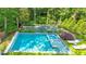 Aerial view of a backyard oasis with a pool, jacuzzi, and tennis court surrounded by lush greenery at 891 Glenbrook Nw Dr, Atlanta, GA 30318