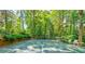 Private tennis court nestled amidst lush greenery, perfect for enjoying outdoor recreation and friendly competition at 891 Glenbrook Nw Dr, Atlanta, GA 30318