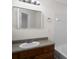 Bathroom with wood cabinets, mirror, tub, and shower area at 11352 Michelle Way, Hampton, GA 30228