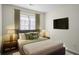 Well-lit bedroom with stylish lamps, a comfortable bed, and a wall-mounted television at 11352 Michelle Way, Hampton, GA 30228
