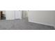 Bedroom area with neutral carpet, base molding, and doorway leading to other parts of the home at 11352 Michelle Way, Hampton, GA 30228