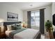 Comfortable bedroom with a queen bed, soft pillows, stylish decor, and large window at 11352 Michelle Way, Hampton, GA 30228
