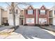 Inviting townhome with a brick facade, black shutters, and a spacious driveway at 11352 Michelle Way, Hampton, GA 30228