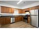 Functional kitchen featuring wood cabinets, stainless steel appliances, and modern floors at 11352 Michelle Way, Hampton, GA 30228