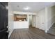 Open-concept living area featuring modern floors, leading to the kitchen and staircase at 11352 Michelle Way, Hampton, GA 30228