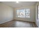 Bright living room featuring hardwood floors and a large window offering neighborhood views at 11352 Michelle Way, Hampton, GA 30228