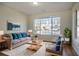 Comfortable living room with a large window, stylish sofa, and modern decor at 11352 Michelle Way, Hampton, GA 30228