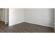 Open living space with hardwood floors, neutral walls, and a staircase visible to the side at 11352 Michelle Way, Hampton, GA 30228