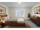Cozy bedroom with a bed, decorative pictures, dresser, and a window overlooking the neighborhood at 11352 Michelle Way, Hampton, GA 30228