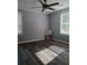 This bedroom has new flooring, a ceiling fan, and plenty of natural light from two windows at 1290 Elizabeth Ave, Atlanta, GA 30310