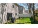 Spacious backyard with lush green lawn, a sliding glass door, and a white fence at 411 Sureyya Dr, Canton, GA 30114
