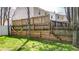 Backyard with wooden retaining wall, hammock, lush green lawn, and mature trees at 411 Sureyya Dr, Canton, GA 30114