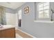 Bathroom featuring a shower-tub, and a light wood vanity, complemented by natural light from two windows at 411 Sureyya Dr, Canton, GA 30114