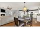 Open concept dining area with modern lighting fixture adjacent to the kitchen and living room at 411 Sureyya Dr, Canton, GA 30114