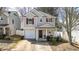 Charming two-story home featuring neutral siding, a single-car garage, and a cozy front porch at 411 Sureyya Dr, Canton, GA 30114