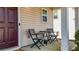 Inviting front porch with seating, a dark red front door, and views of the home's exterior at 411 Sureyya Dr, Canton, GA 30114
