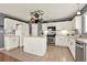 Well-equipped kitchen with white cabinetry, stainless steel appliances, an island and tiled floors at 411 Sureyya Dr, Canton, GA 30114