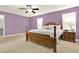Spacious primary bedroom with plush carpet, natural light, and a decorative wooden bed frame at 411 Sureyya Dr, Canton, GA 30114