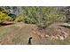 Backyard featuring grass, trees and landscaping rocks at 4152 Berkshire Ct, Villa Rica, GA 30180