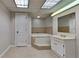 A bathroom featuring a soaking tub, vanity, toilet and tile floors at 4152 Berkshire Ct, Villa Rica, GA 30180