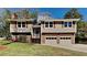 Charming two-story home featuring a brick facade, complemented by a well-maintained lawn and mature trees at 4152 Berkshire Ct, Villa Rica, GA 30180