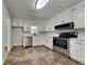 Well-lit kitchen featuring white cabinets, stainless steel appliances, and a corner sink with natural light at 4152 Berkshire Ct, Villa Rica, GA 30180