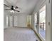 Spacious main bedroom with plush carpet, ceiling fan, double doors leading to the deck, and ensuite access at 4152 Berkshire Ct, Villa Rica, GA 30180