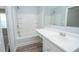 A bathroom with a shower-tub combo, a sink, and vanity mirror at 1851 Devon Dr, Atlanta, GA 30311