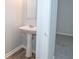 A pedestal sink and mirror combination is next to a doorway at 1851 Devon Dr, Atlanta, GA 30311