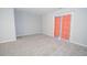 Comfortable bedroom features neutral paint, carpeted floors, and a sliding glass door at 1851 Devon Dr, Atlanta, GA 30311