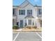 Charming townhome features a well-manicured lawn, white siding, and blue shutters for a classic look at 1851 Devon Dr, Atlanta, GA 30311