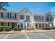 A view of the townhouse with blue shutters, with a landscaped lawn in the foreground at 1851 Devon Dr, Atlanta, GA 30311