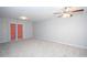 Large open living room includes a ceiling fan and a sliding glass door out to the balcony at 1851 Devon Dr, Atlanta, GA 30311