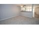 Spacious living room featuring carpet, a ceiling fan, neutral paint, and an open-concept design at 1851 Devon Dr, Atlanta, GA 30311
