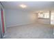 Well-lit open-concept living room showcases carpet, neutral paint, and access to a balcony or patio at 1851 Devon Dr, Atlanta, GA 30311
