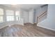 Cozy living room features hardwood floors, a staircase, neutral paint, and many windows for natural light at 1851 Devon Dr, Atlanta, GA 30311