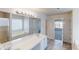 Large bathroom with a tub, double sinks, a view from the window, and plenty of storage space at 40 Kingfisher Walk, Covington, GA 30014