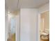 Bright hallway leading to a bathroom with a white toilet and sink at 40 Kingfisher Walk, Covington, GA 30014