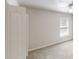 Bright bedroom with neutral carpet, window, and white trim at 40 Kingfisher Walk, Covington, GA 30014