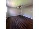 A cozy bedroom is enhanced by plank flooring and a ceiling fan with light fixture at 4701 Flat Shoals Rd, Union City, GA 30291