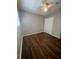 A cozy bedroom featuring wood-look floors, closet with white doors, and natural light at 4701 Flat Shoals Rd, Union City, GA 30291