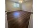 A bright bedroom featuring wood-look floors and large windows with neutral walls at 4701 Flat Shoals Rd, Union City, GA 30291
